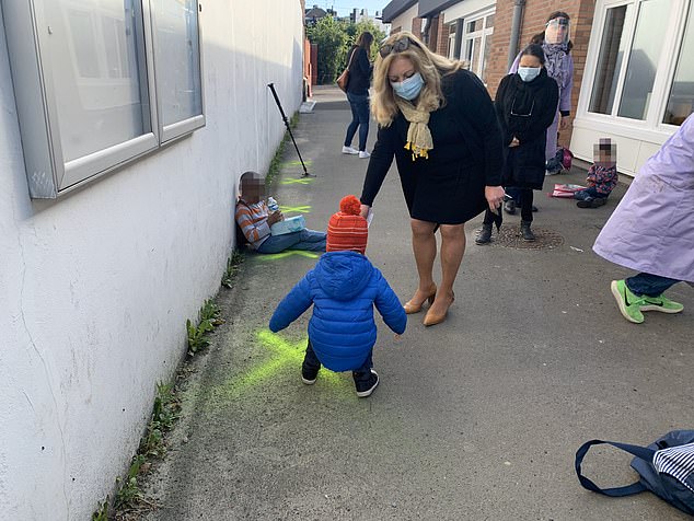 28334180 8314697 Children were also shown lining up by sitting or standing on cro a 2 1589359326192