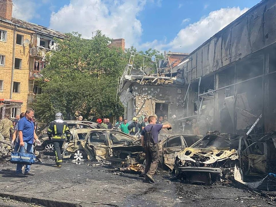60258917 11013171 Firefighters walk among the ruins of burned out cars after Russi a 46 1657794837331