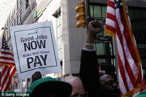 Protestors pass by Wall Street and Broadway in lower Manhattan during the march against banking policy